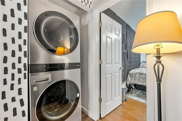1357 Railroad Ave, Sugar Hill, GA 30518 - washroom with stacked washer / drying machine, wood finished floors, and baseboards