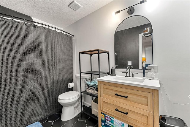 1357 Railroad Ave, Sugar Hill, GA 30518 - bathroom with tile patterned flooring, toilet, vanity, a textured ceiling, and curtained shower