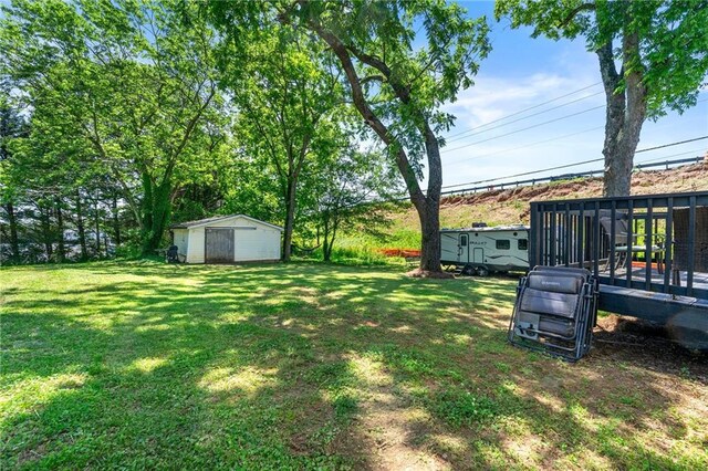 1357 Railroad Ave, Sugar Hill, GA 30518 - bedroom with an AC wall unit, a textured ceiling, and wood finished floors