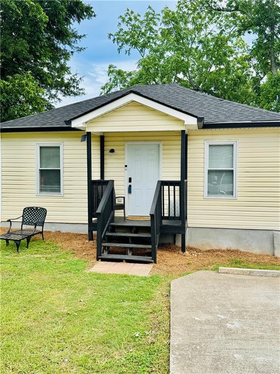 1357 Railroad Ave, Sugar Hill, GA 30518 - view of front of house with a front lawn and roof with shingles