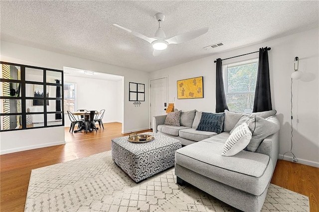 1357 Railroad Ave, Sugar Hill, GA 30518 - living area featuring light wood-type flooring, ceiling fan, baseboards, and a textured ceiling