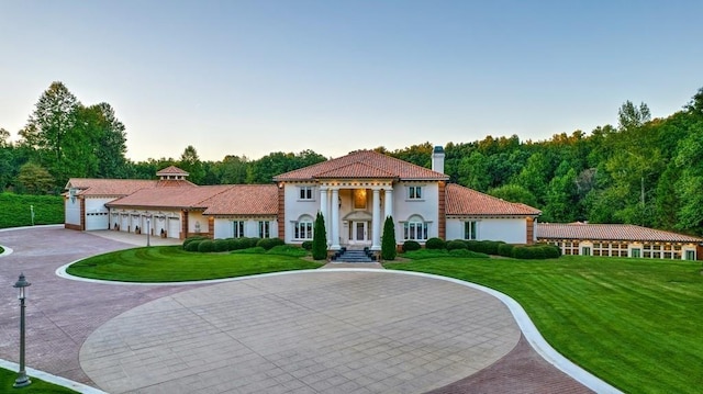 mediterranean / spanish-style home with a front lawn