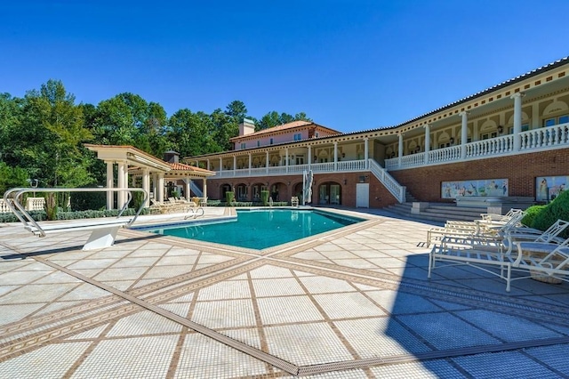 view of swimming pool featuring a patio area