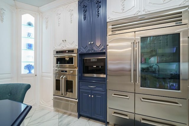 kitchen featuring stainless steel appliances, blue cabinets, and light tile floors