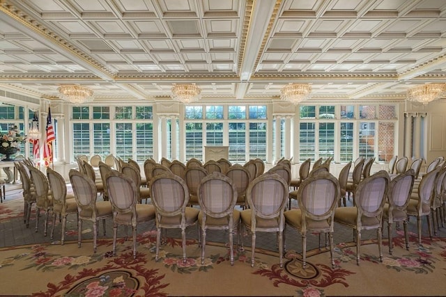 interior space featuring coffered ceiling, a notable chandelier, and a healthy amount of sunlight