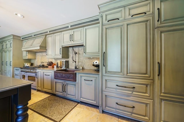 kitchen featuring light tile floors, range with two ovens, custom range hood, and tasteful backsplash