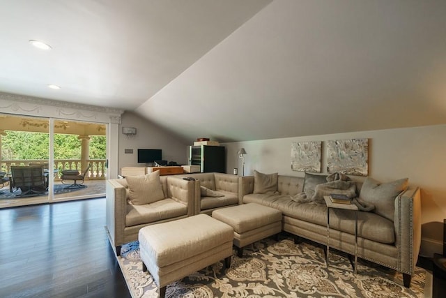 living room featuring lofted ceiling and hardwood / wood-style flooring