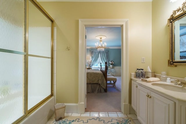 bathroom with an inviting chandelier, bath / shower combo with glass door, tile flooring, vanity, and ornamental molding