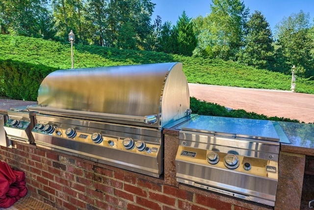 view of terrace featuring grilling area and an outdoor kitchen