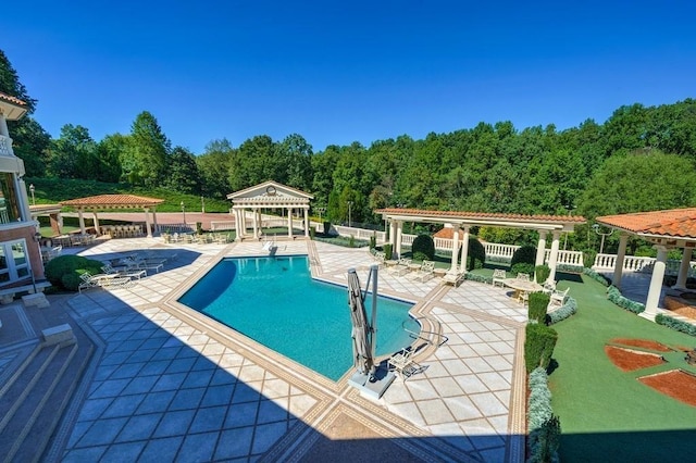 view of swimming pool with a patio and a gazebo