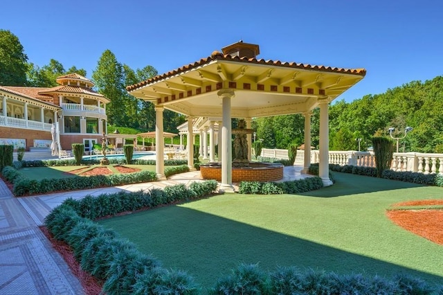 view of property's community featuring a swimming pool and a lawn