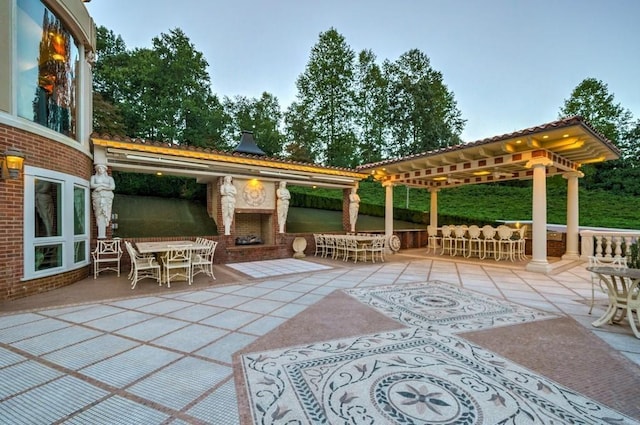 view of patio / terrace with an outdoor fireplace and a pergola