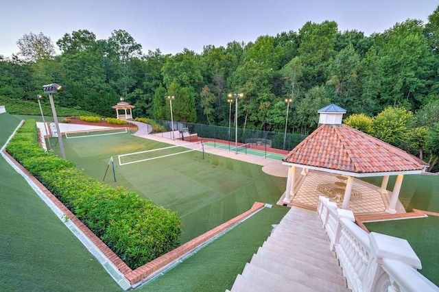 view of property's community featuring tennis court