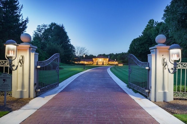 view of gate featuring a lawn