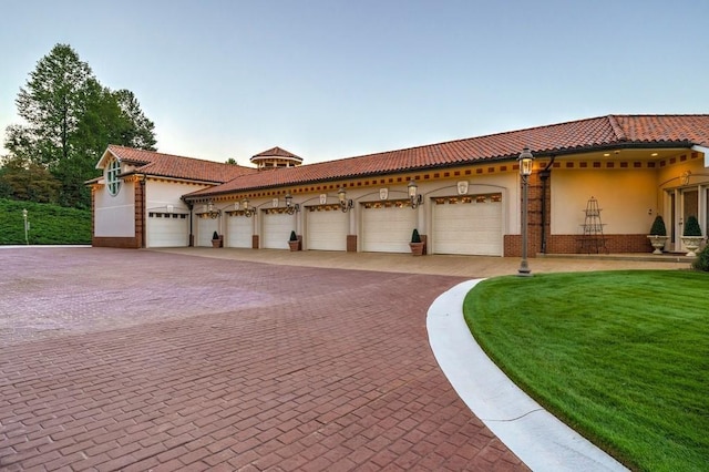 mediterranean / spanish-style house with a front yard and a garage