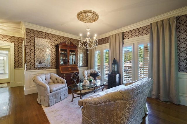 living room with dark hardwood / wood-style flooring, crown molding, and a notable chandelier