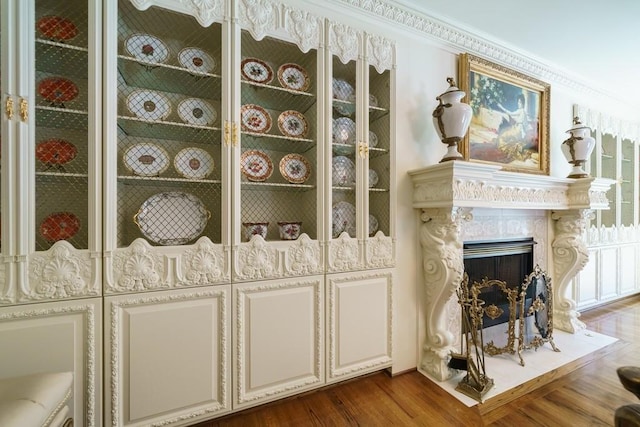 interior space featuring ornamental molding, dark hardwood / wood-style flooring, and a premium fireplace