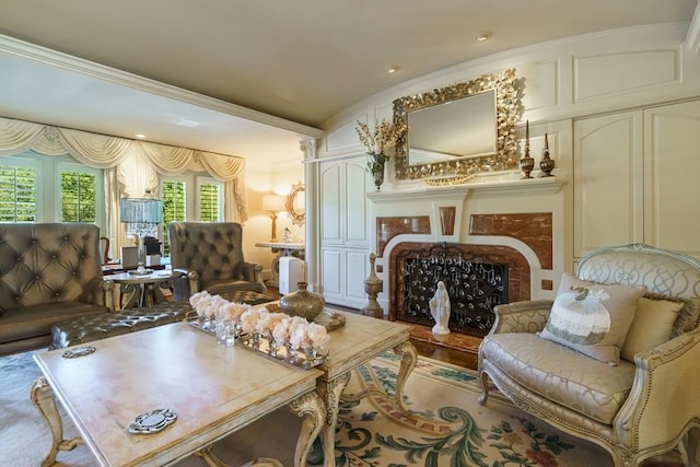 living area with ornamental molding and vaulted ceiling