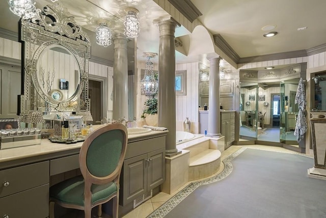 bathroom with crown molding, a bathtub, vanity, and ornate columns