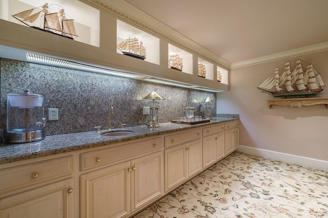 bar featuring tasteful backsplash, light tile floors, sink, ornamental molding, and stone countertops