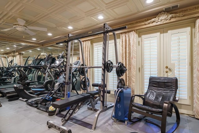 exercise room with coffered ceiling, ceiling fan, and plenty of natural light