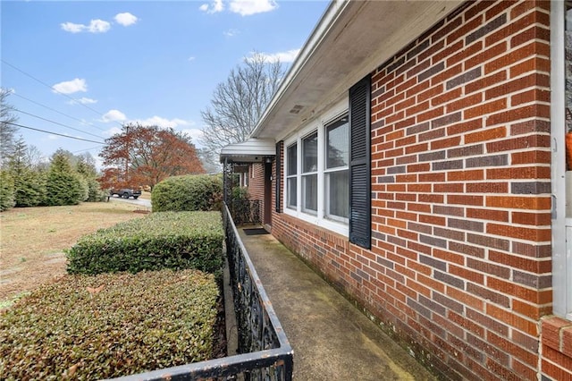 view of side of property with brick siding