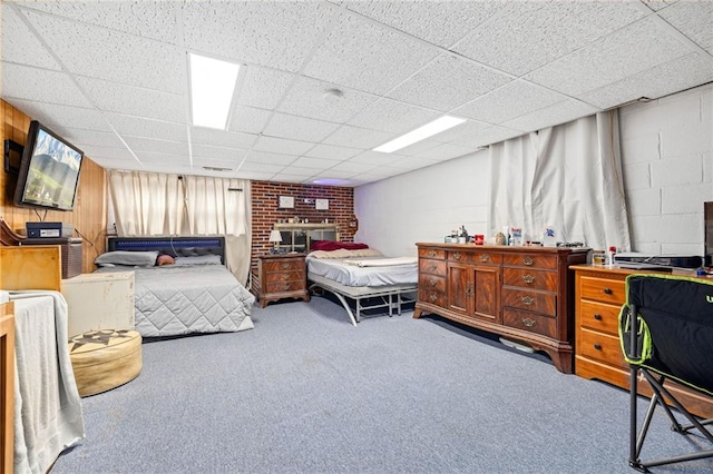 carpeted bedroom with a drop ceiling