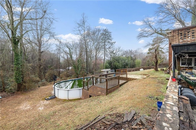 view of yard with a wooden deck and an outdoor pool