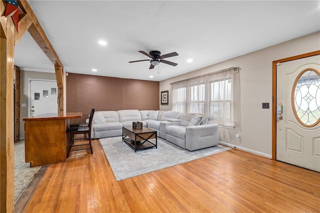 living area featuring a wealth of natural light, baseboards, hardwood / wood-style floors, and recessed lighting