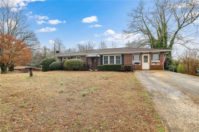 single story home with a front yard and brick siding