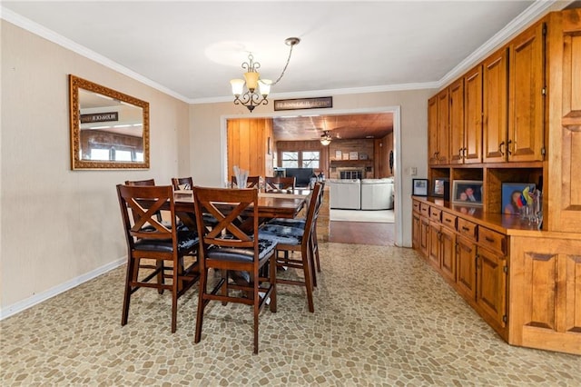 dining room featuring an inviting chandelier, baseboards, and ornamental molding