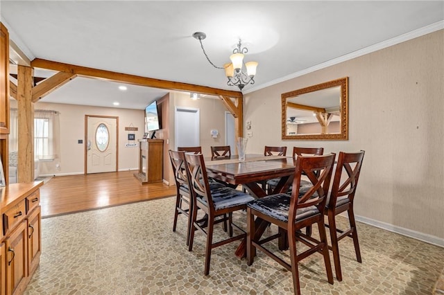 dining space with an inviting chandelier, baseboards, light wood finished floors, and ornamental molding