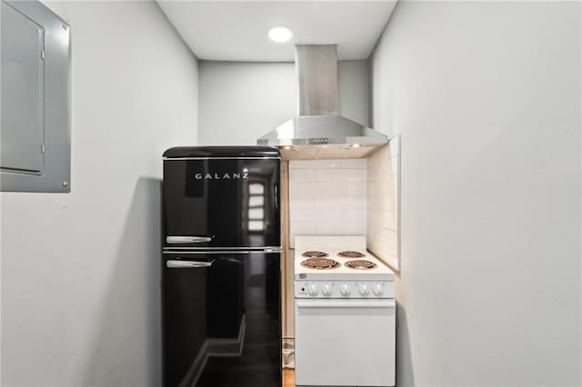 2015 Cascade Rd SW, Atlanta, GA 30311 - kitchen with white electric stove, electric panel, wall chimney range hood, and freestanding refrigerator