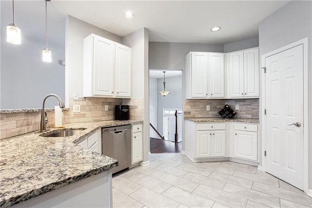 kitchen featuring a sink, light stone countertops, white cabinets, and stainless steel dishwasher