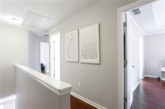 hallway featuring dark wood-style floors, attic access, an upstairs landing, and baseboards