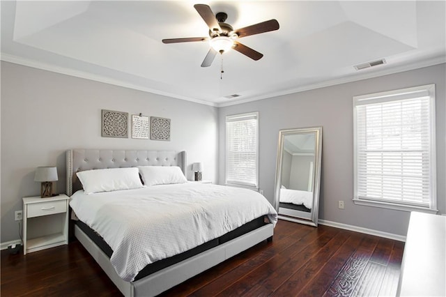 bedroom featuring a raised ceiling, visible vents, baseboards, and hardwood / wood-style flooring