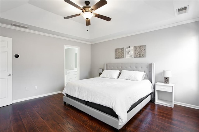 bedroom featuring hardwood / wood-style flooring, baseboards, visible vents, and a raised ceiling