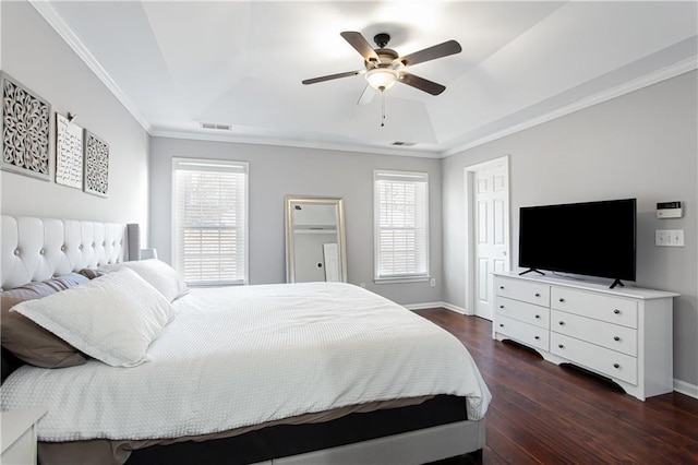 bedroom featuring baseboards, visible vents, a raised ceiling, dark wood-type flooring, and crown molding