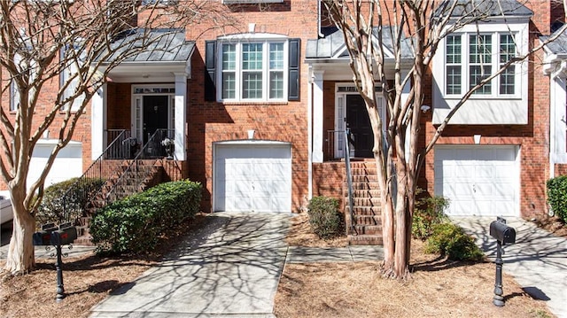 view of front of house with a garage, concrete driveway, and brick siding