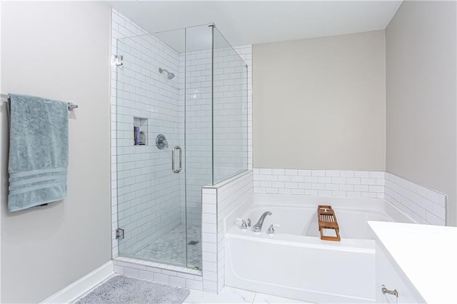 full bath with baseboards, a shower stall, vanity, and a bath