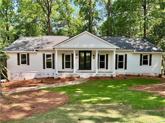 view of front of property with a porch, a front yard, roof with shingles, and crawl space