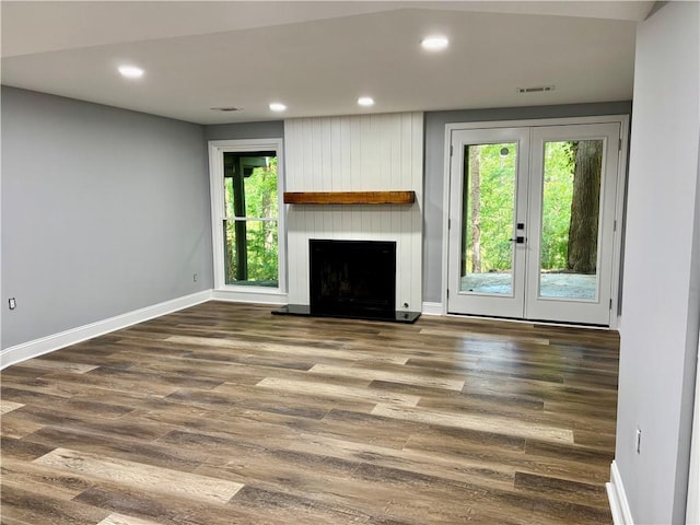 unfurnished living room featuring plenty of natural light, french doors, baseboards, and recessed lighting