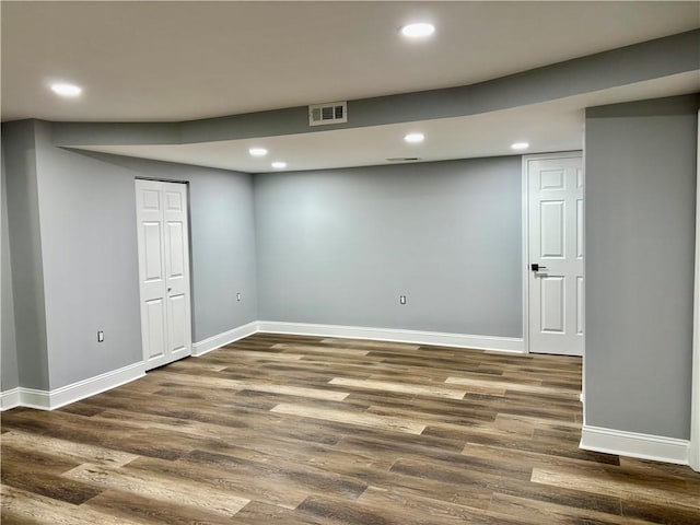 finished below grade area featuring baseboards, dark wood-style floors, and recessed lighting