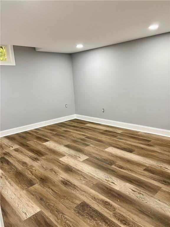finished below grade area featuring dark wood-style floors, recessed lighting, and baseboards