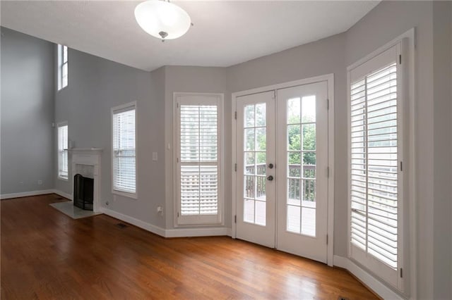2157 Brandon Lee Dr SW, Marietta, GA 30008 - entryway with french doors, wood finished floors, baseboards, and a fireplace with flush hearth