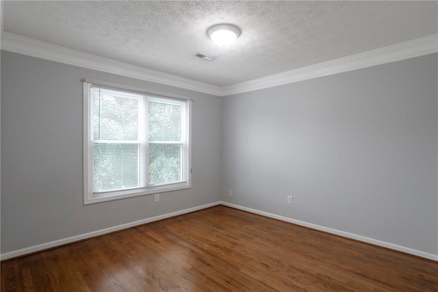 2157 Brandon Lee Dr SW, Marietta, GA 30008 - spare room featuring a textured ceiling, ornamental molding, wood finished floors, and baseboards