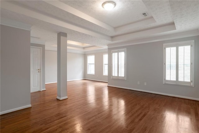 2157 Brandon Lee Dr SW, Marietta, GA 30008 - spare room featuring a raised ceiling, a textured ceiling, baseboards, wood finished floors, and ornamental molding