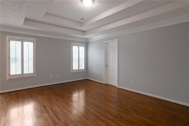 2157 Brandon Lee Dr SW, Marietta, GA 30008 - unfurnished room with a textured ceiling, a tray ceiling, baseboards, and wood finished floors