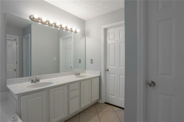 2157 Brandon Lee Dr SW, Marietta, GA 30008 - bathroom featuring a textured ceiling, double vanity, and tile patterned flooring