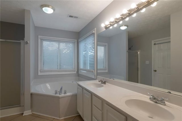 2157 Brandon Lee Dr SW, Marietta, GA 30008 - bathroom featuring a shower stall, a bath, tile patterned floors, double vanity, and a textured ceiling